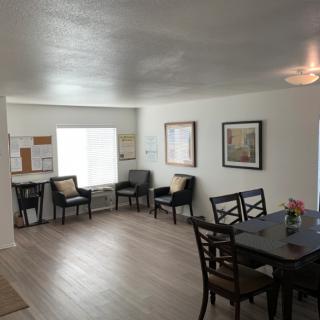 A modern living and dining area with stylish furnishings and bright lighting.