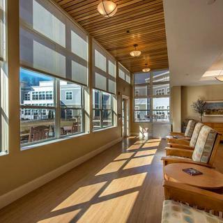 A bright and modern waiting area with large windows and comfortable seating.