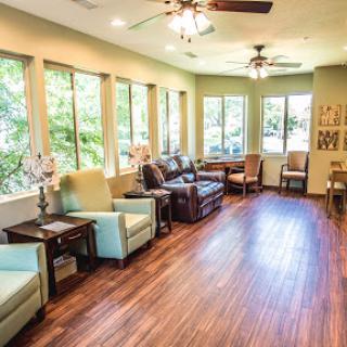 A bright and inviting lounge area with comfortable seating and large windows allowing natural light to fill the space.