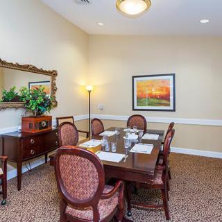 A cozy dining room with elegant furniture and tasteful decor.