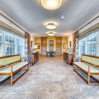 Spacious hallway with seating and large windows.