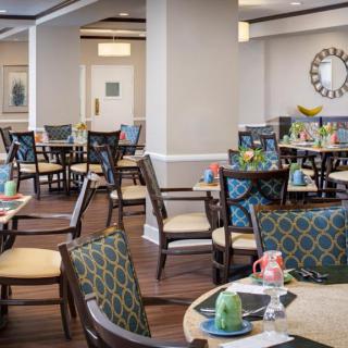 An elegantly decorated dining area with neatly arranged tables and chairs.