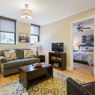 A cozy living room with a view into a neatly decorated bedroom.