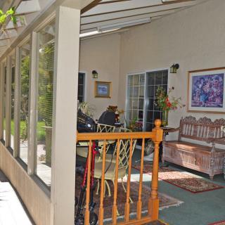 A cozy porch with seating and decorative elements.