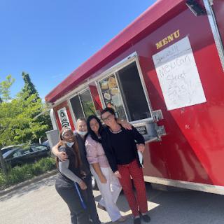 Enjoying a sunny day together by the food truck!