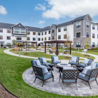 A well-designed courtyard with comfortable outdoor seating at a modern apartment complex.