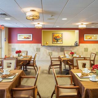 An elegantly decorated dining room with neatly arranged tables and chairs.