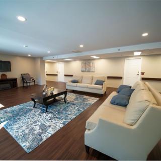 A modern living room with comfortable sofas, a stylish coffee table, and decorative rugs.