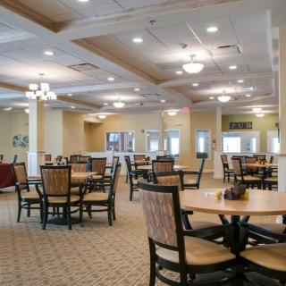 A spacious dining room with neatly arranged tables and chairs.