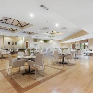 Spacious and elegantly decorated restaurant interior with neatly arranged tables and chairs.