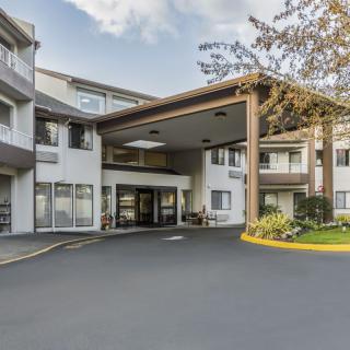 A residential building entrance with a covered driveway area.
