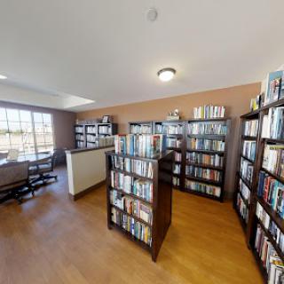 A cozy library filled with books, providing a perfect spot for reading and relaxation.