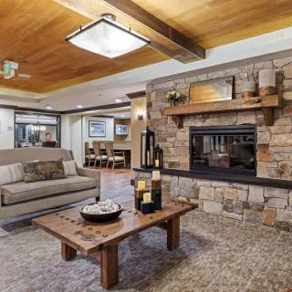 Cozy living room with a stone fireplace and modern decor.