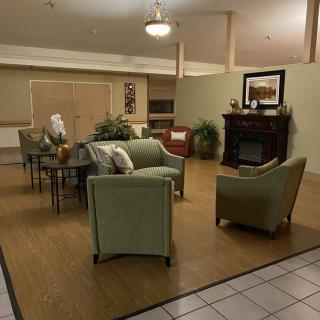 A cozy living room with comfortable seating and a fireplace.