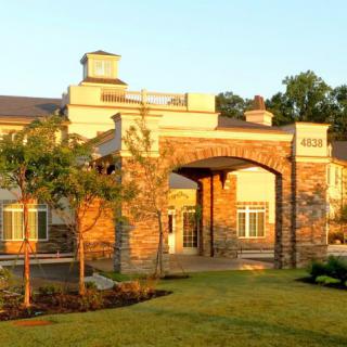 A scenic view of a building entrance bathed in sunlight.