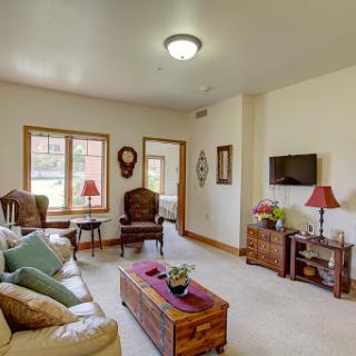 A cozy living room featuring comfortable seating, warm lighting, and decorative touches.