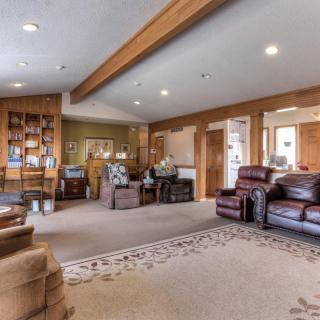A spacious and cozy living room with comfortable seating and wood accents.