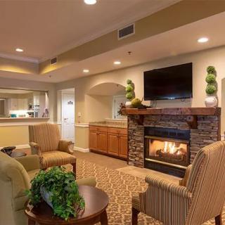 A cozy living room with modern decor, featuring a fireplace and comfortable seating.