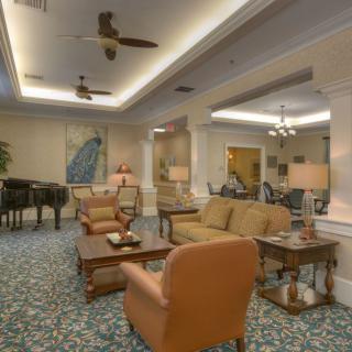 A cozy and elegantly designed lounge area with comfortable seating and warm lighting.
