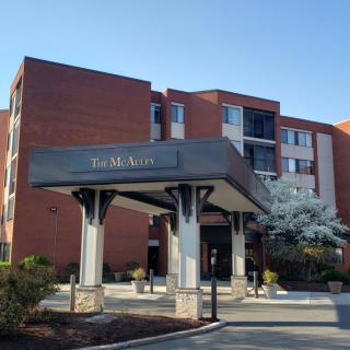 The exterior view of a hotel with a covered entrance.