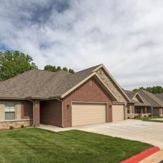 A suburban house with a two-car garage and well-maintained lawn.