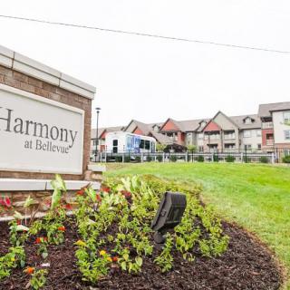 A residential complex with a sign reading 'Harmony at Rutherford', surrounded by landscaped gardens.