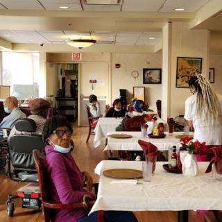 Residents enjoying lunch together in a communal dining area.