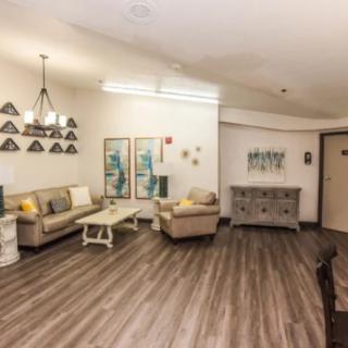 A modern living room with stylish furniture and artwork on the walls.