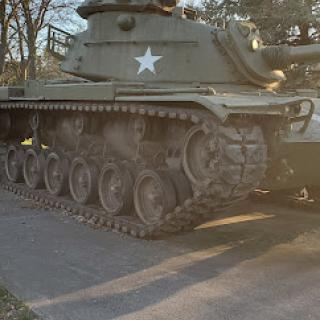 A vintage military tank parked outdoors.