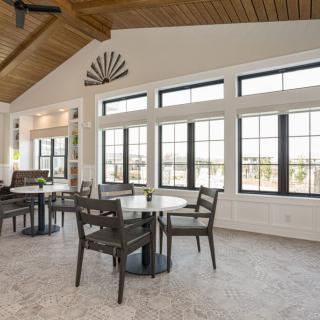 A modern dining area with large windows and abundant natural light.