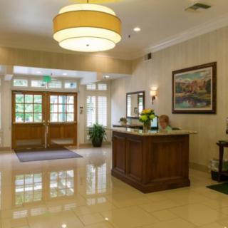 A well-lit lobby with a reception desk and modern decor.
