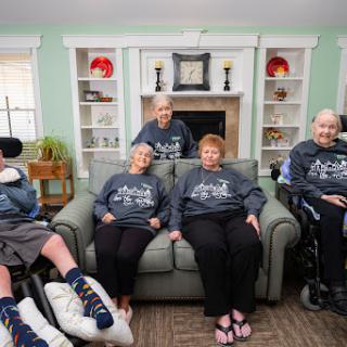 A warm gathering of residents in a care facility, showcasing camaraderie and comfort.