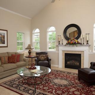 A cozy and elegant living room with a fireplace, sofa, and stylish decor.