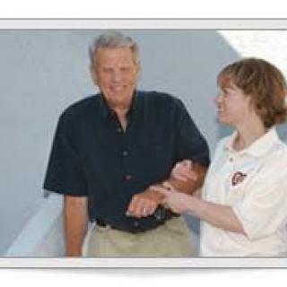 A person assists another individual in a casual setting.