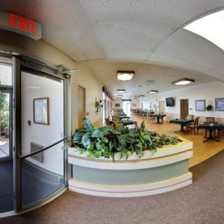 A spacious lobby with seating areas and decorative plants.