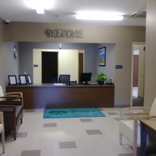 A welcoming office lobby with a reception desk and seating area.