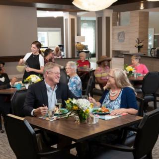 A group of people enjoying a meal together in a restaurant setting.