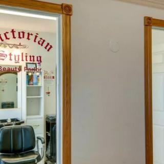 Interior view of a barber shop with styling chairs and mirrors.