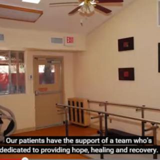 A healthcare rehabilitation room equipped with parallel bars for patient therapy.