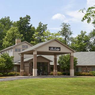 A view of a building surrounded by trees and greenery.