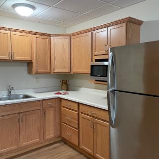 A modern kitchen featuring wooden cabinets and stainless steel appliances.