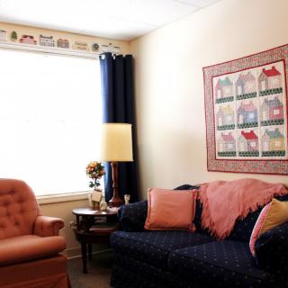 Cozy living room with a couch, armchair, and decorative elements.