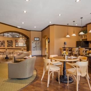 A cozy cafe interior with stylish furniture and warm lighting.