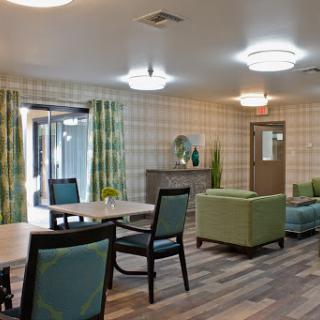A modern lounge area featuring comfortable furniture and bright decor.