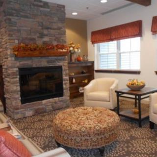A cozy living room featuring a stone fireplace and comfortable seating.
