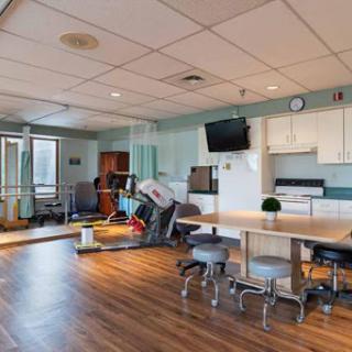 A bright and spacious rehabilitation room equipped with therapy tools and a welcoming atmosphere.