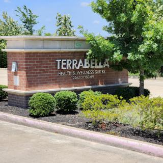 The entrance sign of Terrabella, showcasing a well-maintained landscape.