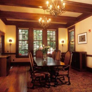 A classic dining room with wooden furniture and elegant chandeliers.