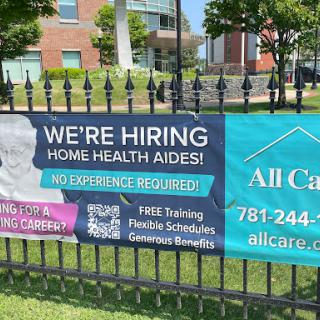 A banner advertising job openings for home health aides with no prior experience necessary.
