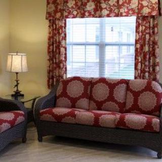 A cozy living room with patterned sofas and curtains.